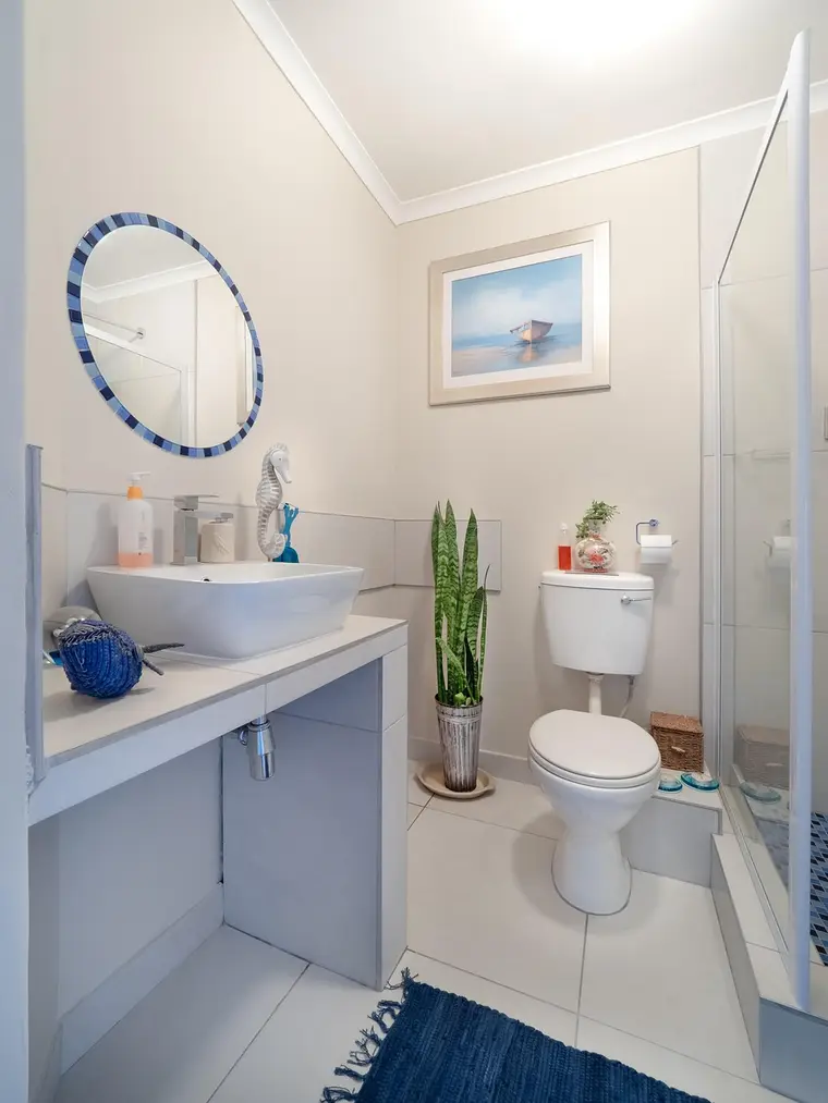 Tiled bathroom with a shower, bath, toilet and basin